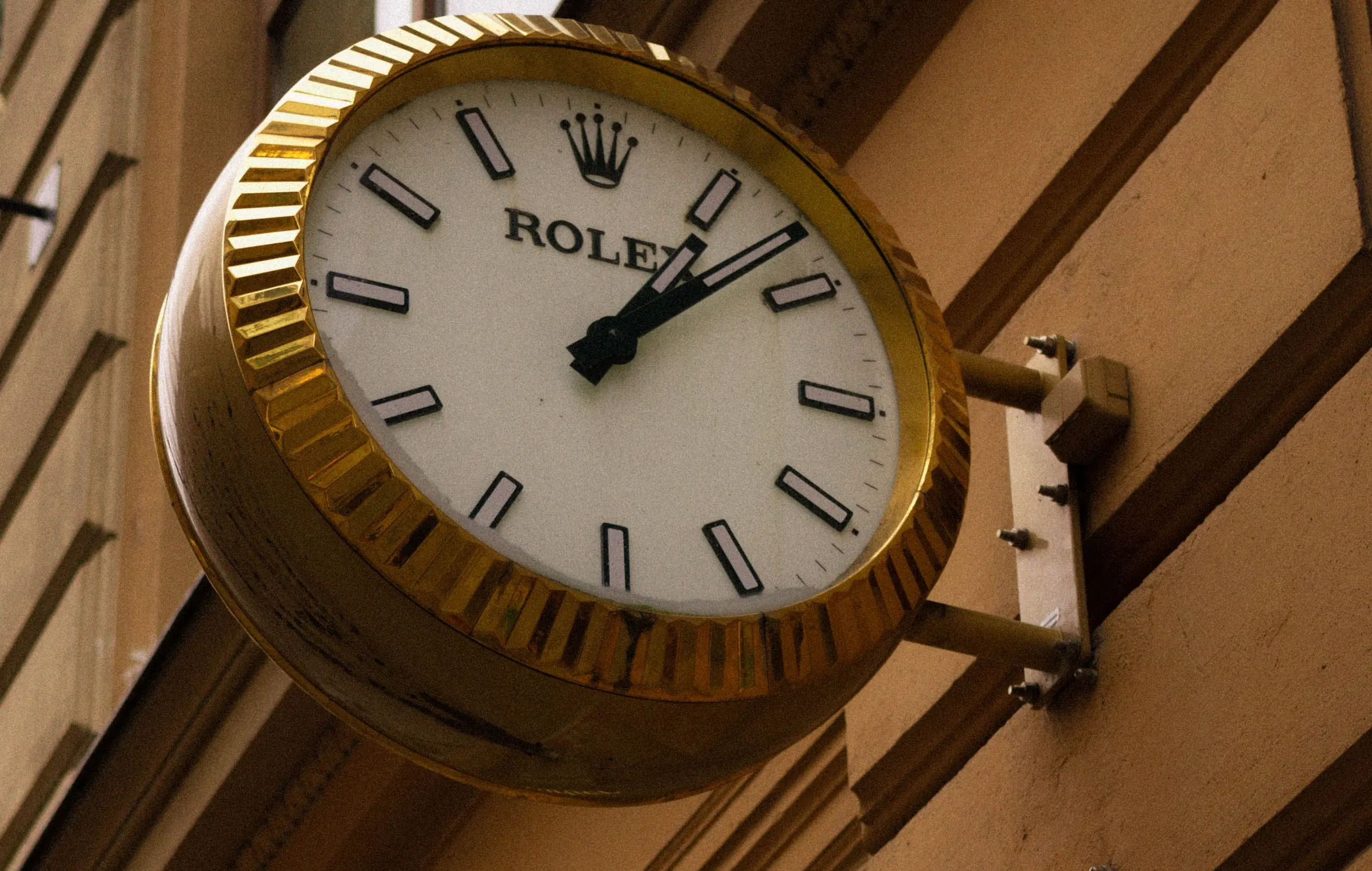 Rolex boutique street clock on a classical stone facade