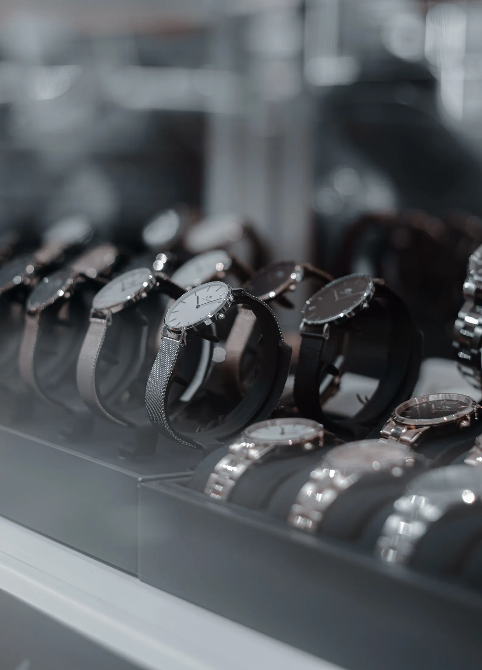 Collection of luxury watches resting on dark presentation stands